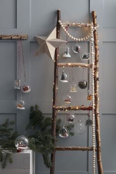 a wooden ladder decorated with ornaments and lights