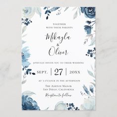 an elegant floral wedding card with blue flowers and leaves on the front, in black ink