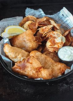 a plate full of fried food with dipping sauce