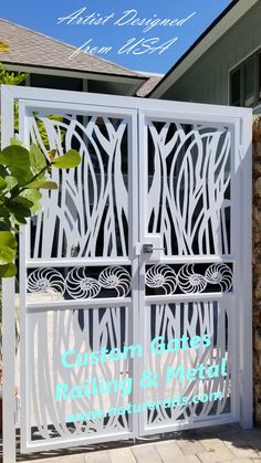 a white gate with an intricate design on it