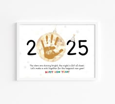 a card with the number twenty five and handprints on it that says, happy new year