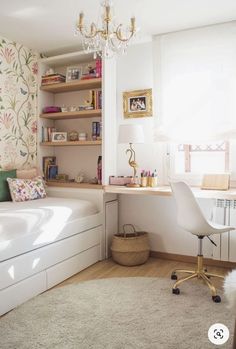 a bedroom with a bed, desk and chair next to a wallpapered wall