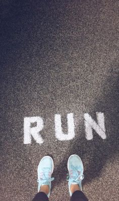 someone standing in front of the word run painted on the ground