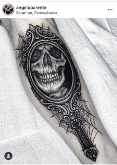 a skull with a magnifying glass on his arm