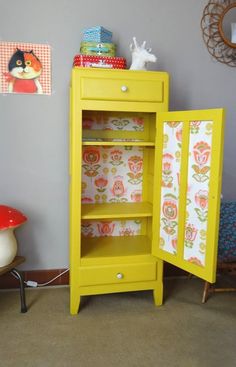 a yellow cabinet sitting in the corner of a room