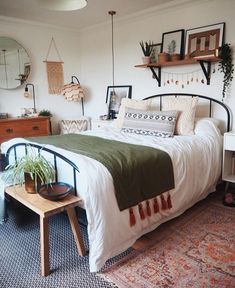 a bed room with a neatly made bed and lots of decorations on the wall above it