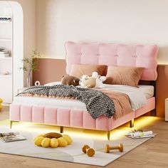 a bedroom with pink bedding and white rugs on the wooden floor, along with yellow accessories