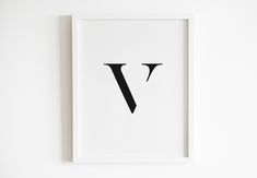 a black and white print with the letter v in it's center, on a wall