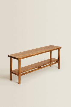 a wooden bench sitting on top of a white floor