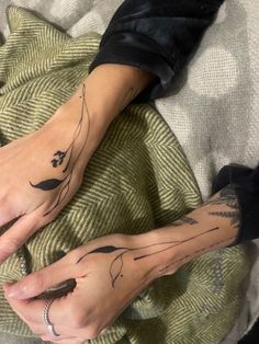 two people with matching tattoos on their hands