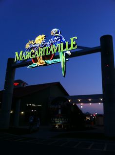 the sign for margaritaville is lit up at night