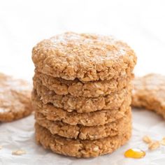 cookies stacked on top of each other with oats scattered around them in front of the camera