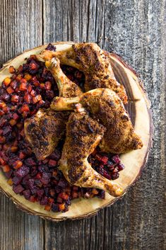 cooked chicken with cranberry sauce and potatoes on a wooden platter, top view from above