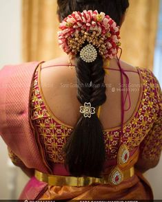 the back of a woman's head with flowers in her hair