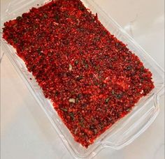 a plastic container filled with lots of red food