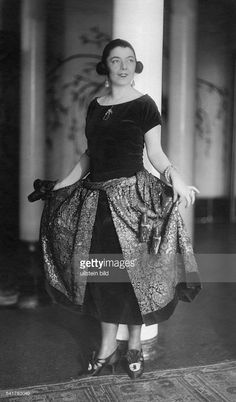 a woman in an elegant dress poses for the camera