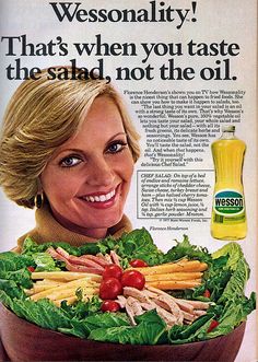 a woman holding a salad with lettuce and carrots