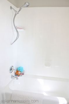 a white bath tub sitting next to a shower head