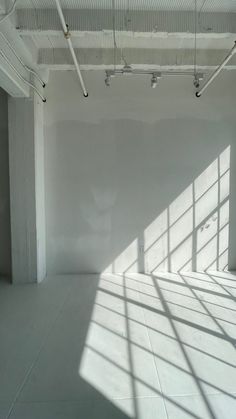 an empty white room with lots of windows