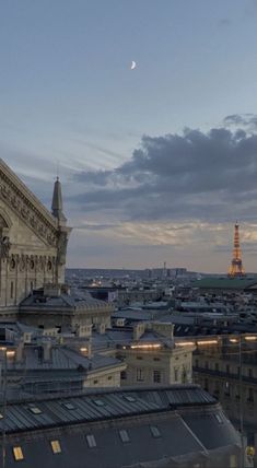 a view of the city at night from an apartment building in paris, with the eiffel tower in the distance