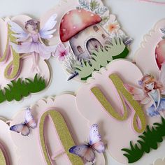 the letters are made out of paper and decorated with flowers, butterflies, and fairy images