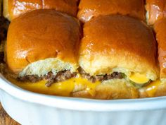 cheeseburger sliders in a casserole dish with melted cheese on top