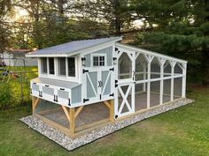 a chicken coop in the middle of a yard