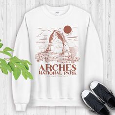 Arches National Park Sweatshirt | Arches National Park Shirt | National Park Gift | Camp Hiking Arches Park Sweater | Utah parks * 50% cotton, 50% polyester * Pre-shrunk * Classic fit * 1x1 athletic rib knit collar with spandex * Air-jet spun yarn with a soft feel and reduced pilling * Double-needle stitched collar, shoulders, armholes, cuffs, and hem Arches Park, National Park Sweatshirt, Utah Parks, National Park Gifts, National Park Shirt, Arches National Park, Camping Gifts, Favorite Shirts, Stitch Fix