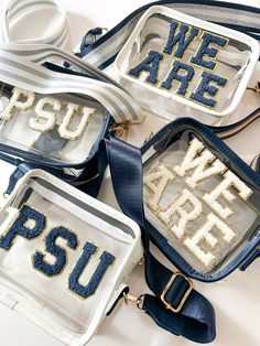 four purses that say we are psu on the front and one with sequins