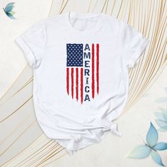 America Shirt, USA Flag Tshirt, Independence Day Tee, Red White And Blue Outfit, Patriotic American Flag Shirt, American Flag Tee, USA Shirt. These t-shirts often feature a design bearing the national symbols and colors of the United States. They are also frequently preferred during election periods. How To Order: - Please, check all tees color and  size charts. - Select your shirt size, color and quantity from the drop-down menu. - Click the "Add to cart" button. You can come back to add more i Red Crew Neck T-shirt With Flag Print, Patriotic Red Top With American Flag, Patriotic Red T-shirt With American Flag Print, Red Patriotic T-shirt With American Flag Print, Red Patriotic Shirt With Letter Print, Red Patriotic American Flag Top, Red Flag Print T-shirt For 4th Of July, Patriotic Red Cotton T-shirt, Red Patriotic Letter Print Shirt