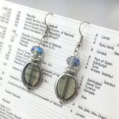 Silver and gray glass and crystal dangle earrings. Handmade by NewsomJacksonDesigns. These earrings are made with high-quality glass beads and metal wire (safe for sensitive ears). The perfect accompaniment for your bossgirl power all-black outfit. They've got a classy/mysterious vibe- good for the office or a Friday night date! Approximately 1.5 inches long. Ready to ship! Orders will be shipped 1-3 business days from the East Coast of the USA in gift-quality packaging. Please let me know if you have any special requests (ex. if the order is a gift)- I will do my best to take care of any requests! If you would like a custom design, or multiple of an item (everything is one-of-a-kind, so multiples will have to be special made), please message me directly! These are handmade by the super-cr Silver Glass Drop Crystal Earrings, Silver Crystal Earrings For Jewelry Making, Adjustable Silver Glass Beaded Earrings, Night Date, Crystal Dangle Earrings, Grey Glass, All Black Outfit, Etsy Earrings Dangle, Metal Wire