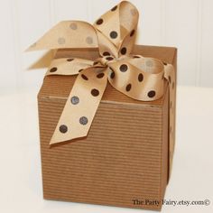 a brown box with polka dot ribbon on it