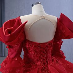 a red dress is displayed on a mannequin