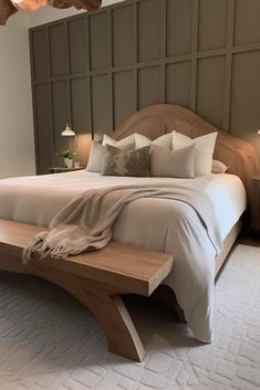 a bedroom with a large bed and wooden headboard