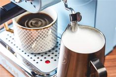 an espresso machine pouring milk into a cup