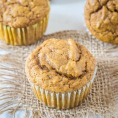 three muffins sitting on top of a burlly cloth