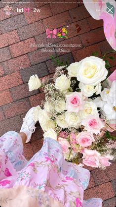 a bouquet of white and pink flowers on the ground