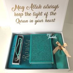 an open box containing two necklaces and a card that says, may allaah always keep the light of the quran in your heart