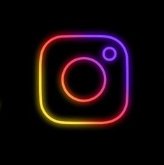 the instagram logo is lit up in neon colors on a black background, and it appears to be glowing