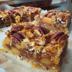 pieces of pecan bar sitting on top of a piece of paper