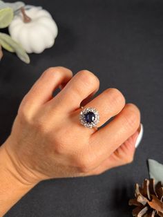 a woman's hand with a diamond and sapphire ring