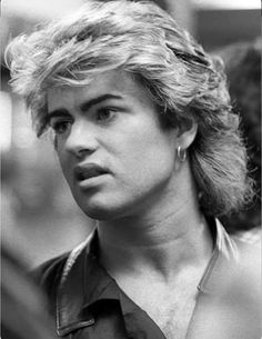 a black and white photo of a man with blonde hair