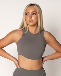 Achieve a feminine silhouette effortlessly with our Sleeveless Crop tank. Boasting a curved Raw Edge hem and a classic crew neckline, this tank is a versatile addition to your wardrobe. Its easy layering over any sports bra makes it the perfect choice for any activity or occasion! Sporty Sleeveless Activewear With Built-in Bra, Sporty Sleeveless Moisture-wicking Crop Top, Elastane Tank Activewear With Built-in Bra, Fitted Cropped Activewear With Built-in Bra, Micro-elastic Sleeveless Activewear With Built-in Bra, Feminine Silhouette, Tan Color, Charcoal Color, Crop Tee