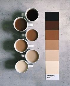 there are coffee cups on the table next to each other and a pantone color chart