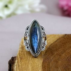 TITLE: -  Labradorite Ring, 925 Sterling Silver Jewelry, Marquise Shape Ring, Designer Split Band Ring, Vintage Style Ring, Statement Ring, Boho Ring SPECIFICATIONS: - ❖ Metal:  925 Solid sterling silver ❖ Gemstone:   Labradorite ❖ Gemstone Size: 10x28mm ❖ Total Weight:  9.3 Gram ❖ Gemstone Setting:  Bezel Note: Our use of natural stones may result in slight variations in texture and color in the actual product you receive, but the quality and grade of the stone remain consistent. FEATURES: -  * Held in a bezel setting, the elegant marquise shape labradorite dazzles in its mesmerizing hue. It is flanked by vintage style motifs adding a timeless touch. This marquise labradorite ring in 925 sterling silver is designed with a unique shank.  * About Gemstone : Labradorite displays a iridescent Gemstone Setting, Chunky Ring, Vintage Style Rings, Chunky Rings, Black Onyx Ring, Labradorite Ring, Ring Boho, Boho Ring, Silver Accessories