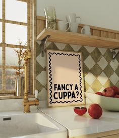 an image of fancy cuppa sign on the kitchen counter with apples and coffee mugs