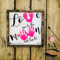 a sign that says, be you to the moon and back with pink handprints