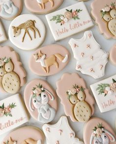 decorated cookies are arranged on a table for someone's baby shower or first birthday