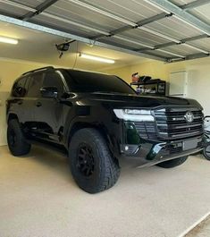 a large black truck parked in a garage