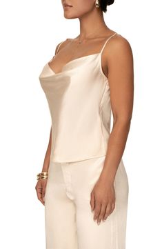 Add a graceful note to your look with the softly draped neckline of this luminous satin camisole. Cowl neck Adjustable straps 55% rayon, 45% viscose Hand wash, dry flat Imported Elegant Satin Camisole With Built-in Bra, Elegant Tank Top With Delicate Straps For Evening, Elegant Evening Tank Top With Delicate Straps, Silk Camisole With Tank Straps For Evening, Satin Camisole With Delicate Straps, Feminine Satin Camisole With Built-in Bra, Feminine Satin Camisole With Spaghetti Straps, Elegant Satin Tank Top With Delicate Straps, Feminine Satin Tank Top For Party